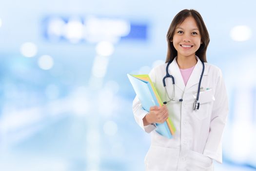 Young medical doctor woman. Southeast Asian medical student standing on hospital background.