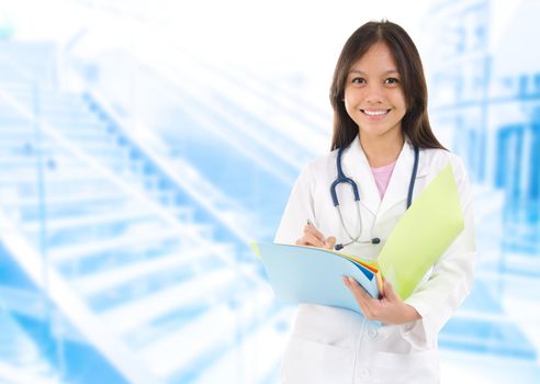 Southeast Asian medical student. Young medical doctor woman standing on hospital background.