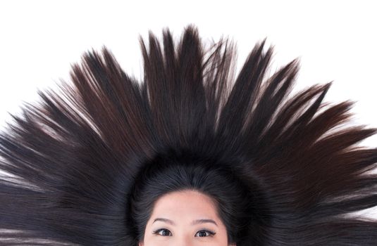 Beautiful young Asian girl lying on white with scatter hair