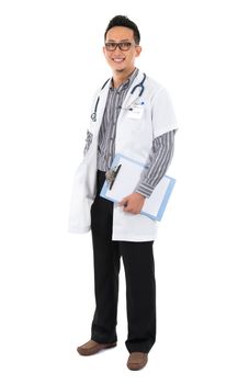 Full body southeast Asian medical doctor. Male medical doctor holding a clipboard standing on white background with confident smile.