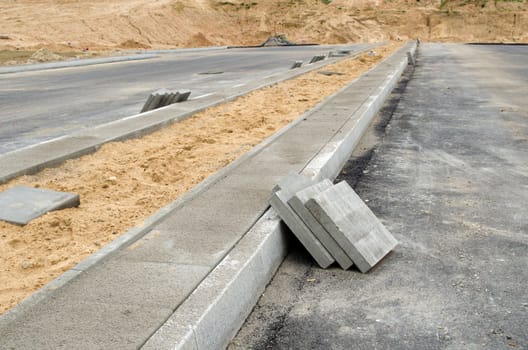 pavement tiles on new sidewalk. new highway asphalt road construction works.