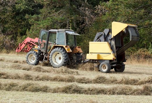 tractor and machine with straw bales