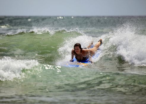 Woman-surfer in ocean. Bali. Indonesia