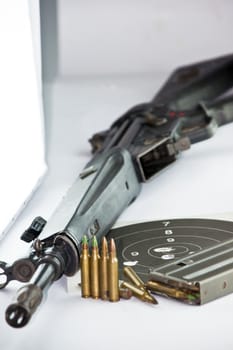 Close up of rifle and bullets on white background