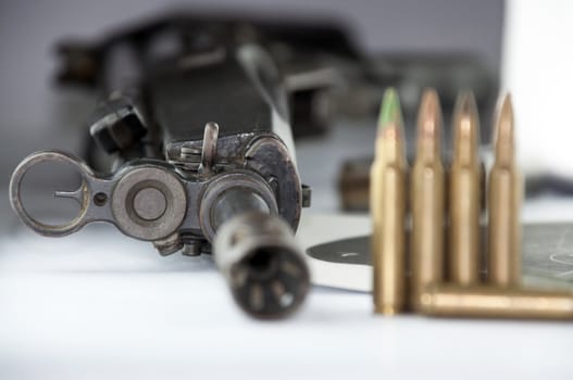 Close up of rifle and bullets on white background