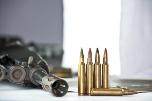 Close up of rifle and bullets on white background