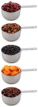A variety of dried fruit - cranberries, sultanas, currants, apricots and raisins - in cup measures, isolated on a white background