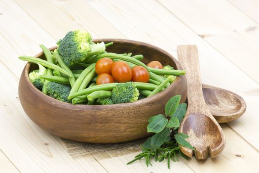 Vegetables and herbs: broccoli, green beans and tomatoes in a bowl