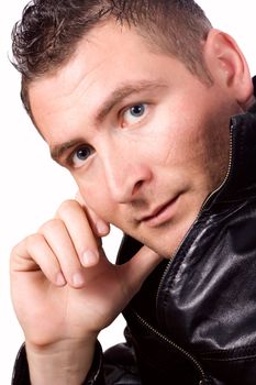 Portrait of a good looking man in classic leather jacket with hand on head
