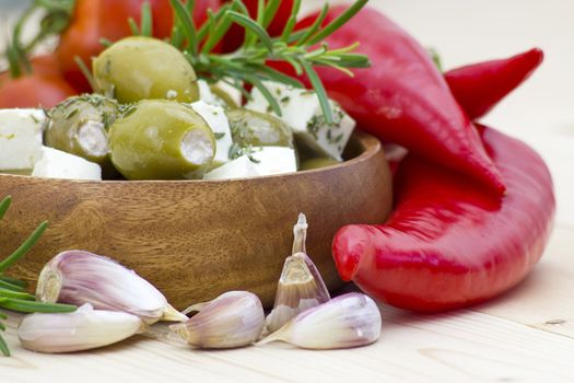 feta cheese and olives with herbs in olive oil
