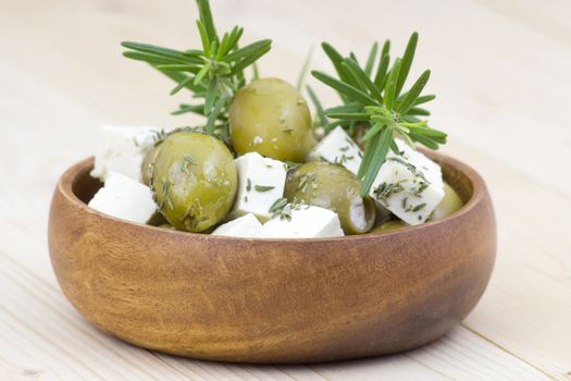feta cheese and olives with herbs in olive oil