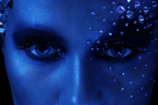 Blue portrait of beautiful woman with artistic make-up