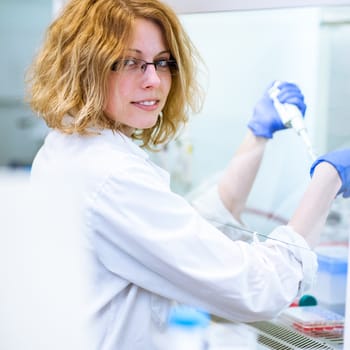 Portrait of a female researcher doing research in a lab (shallow DOF; color toned image)