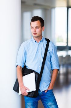 Handsome college student on campus (shallow DOF; color toned image)