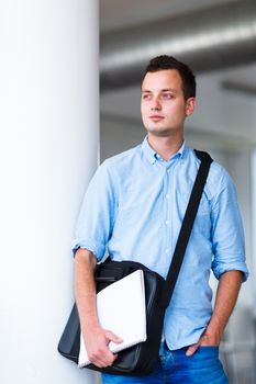 Handsome college student on campus (shallow DOF; color toned image)