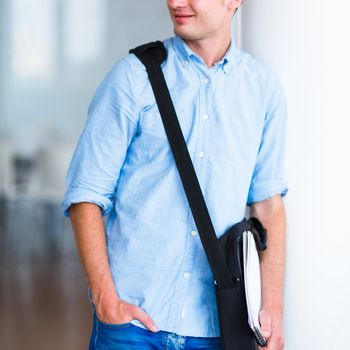 Handsome college student on campus (shallow DOF; color toned image)