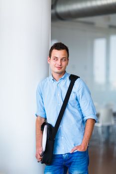 Handsome college student on campus (shallow DOF; color toned image)