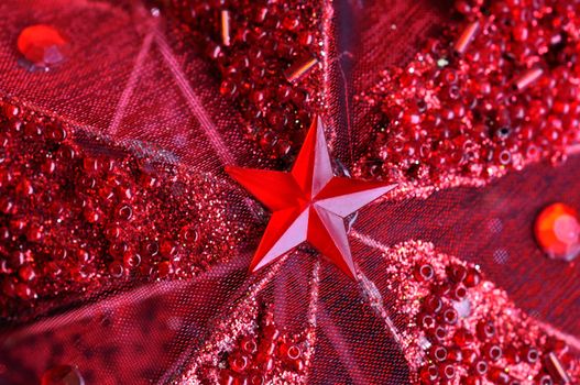 Christmas seasonal background with red star and glitter.