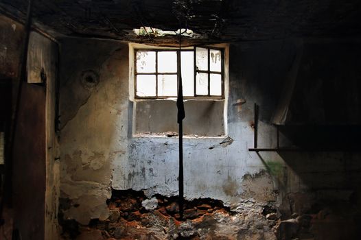 Sunlight through the broken window of an abandoned factory.