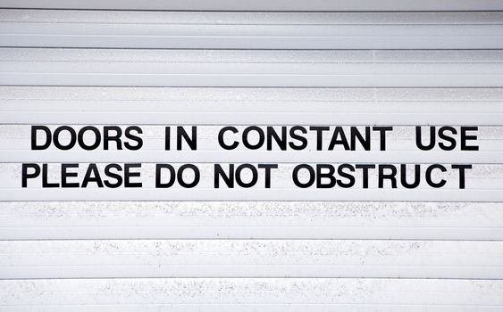 Sign on Garage Doors.