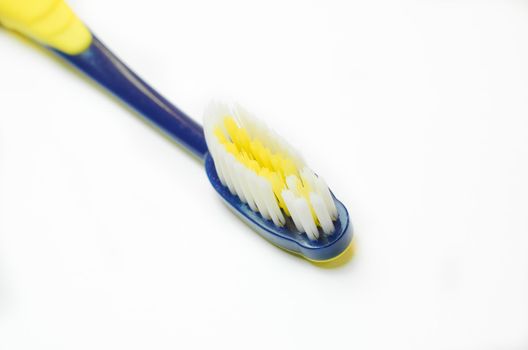 Tooth-brush with blue handle over white background