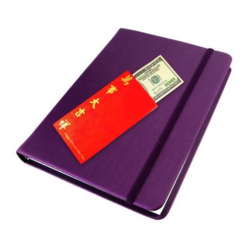 Money dollar cash banknote in red envelope on purple notebook isolated on white for chinese new year