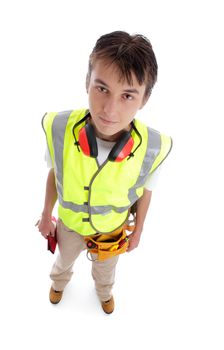 Young male builder apprentice tradesman rookie wearing protective work gear standing on a white background.