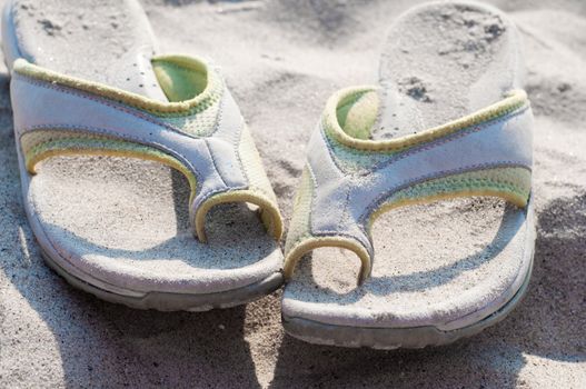 Shot of  flip flops on sand, sunny day