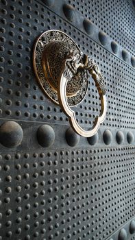 Ancient iron door with a copper doorknob