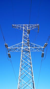 High voltage transmission lines against blue sky
