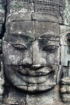 Giant ancient buddha rock statue at Angkor Cambodia
