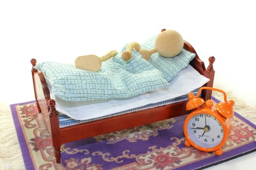 a wooden bed and alarm clock on a white background