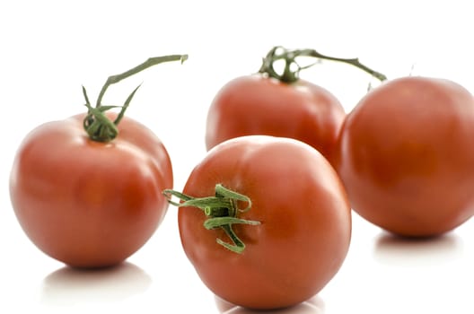 A group of fresh tomatoes isolated on a white background.