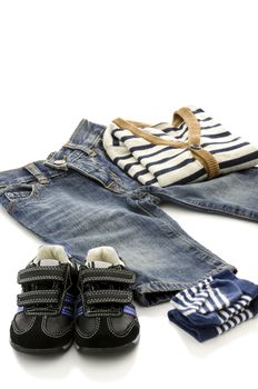 Prepared clothes for a baby boy isolated on a white background.