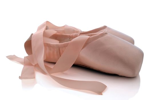 Brand new ballet shoes isolated on white background .