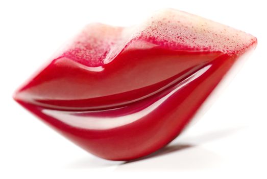 Burgundy Lips shaped Praline on white background.