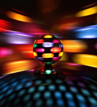 Colorful disco ball rotating light spot reflections on wall
