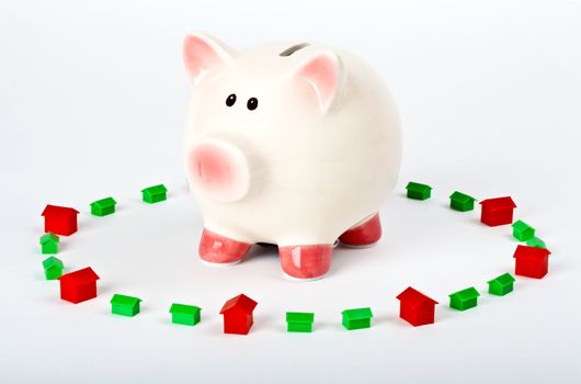 Piggy Bank surrounded by Housing and Property.  Saving and Investing in Property.