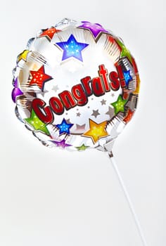 A 'Congratulations' balloon over a plain background.