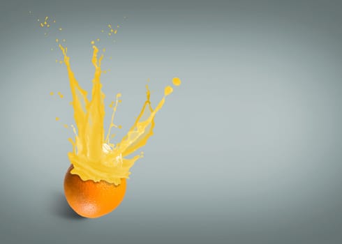 ice cubes fall into the orange, spray and splashes of juice