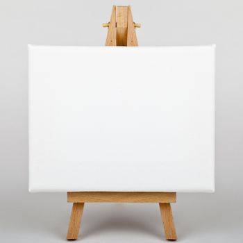 A white canvas on an easel.