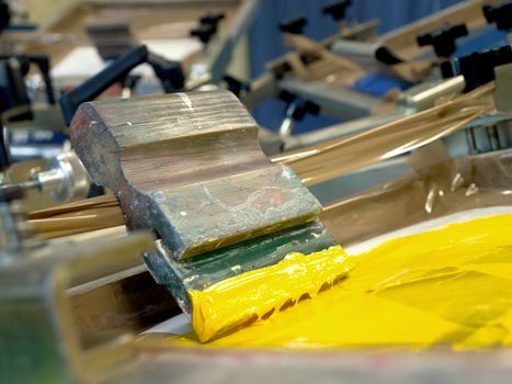 yellow screen printing ink and squeegee