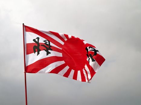 japan navy flag over light gray sky