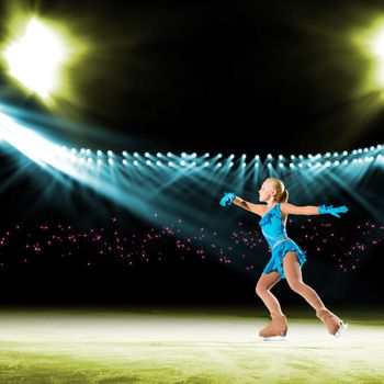 young skater performs on the ice in the background lights lighting