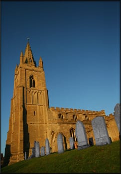 13th century church in Epingham against blue sky