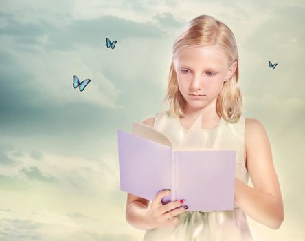 Little Blonde Girl Reading a Book with Butterflies
