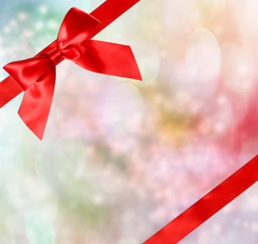 Red Bow and Ribbon with Pastel Bokeh Lights Background 