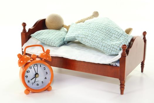 a wooden bed and alarm clock on a white background