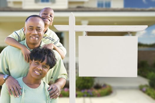 African American Family In Front of Blank Real Estate Sign and New House.