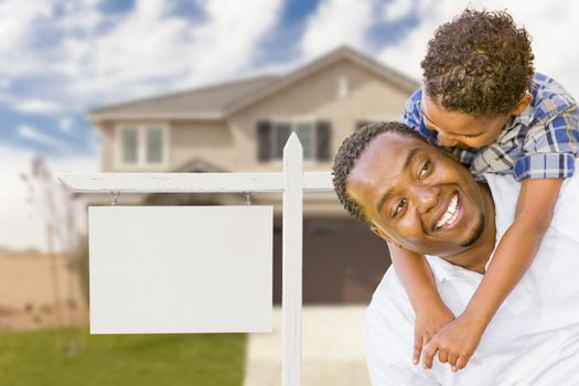 Happy African American Father and Mixed Race Son In Front of Blank Real Estate Sign and New House.